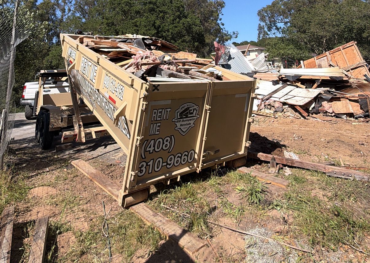 Demolition debris loaded into an RM dumpster